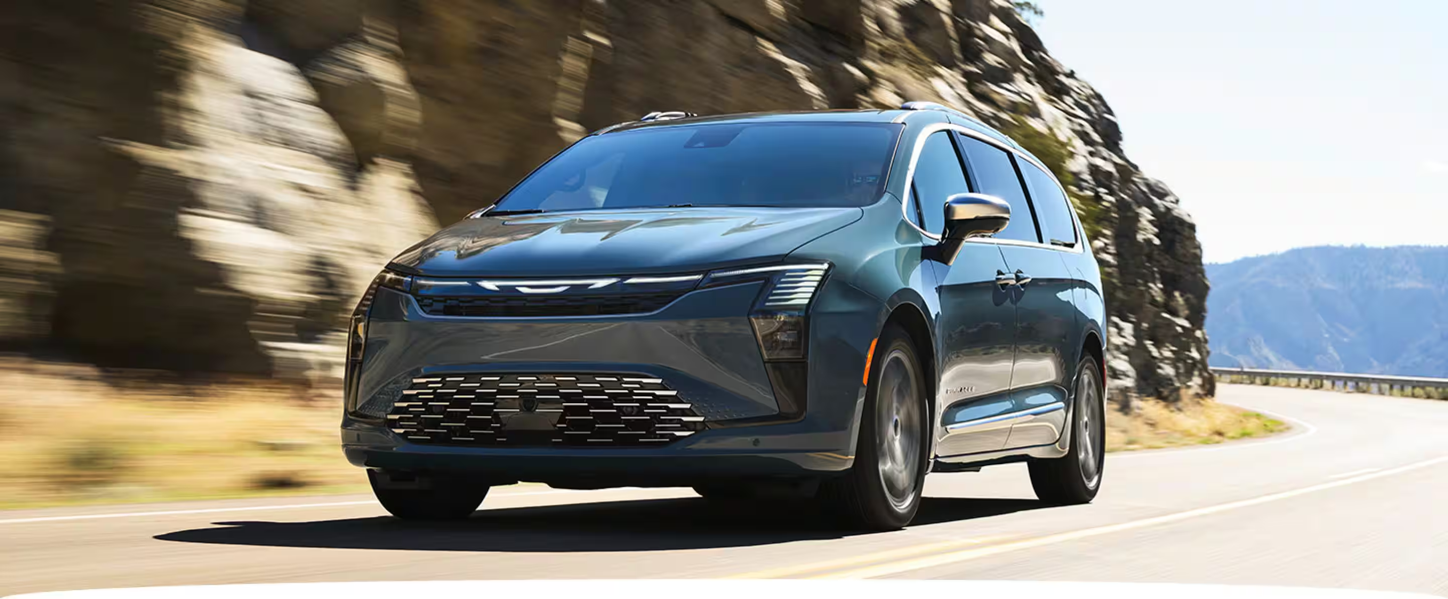 it has a center bar that flows into the "badge", which continues the bar across the grille and has 2 downward uhh fangs, nested below is a wide U shape kinda thing